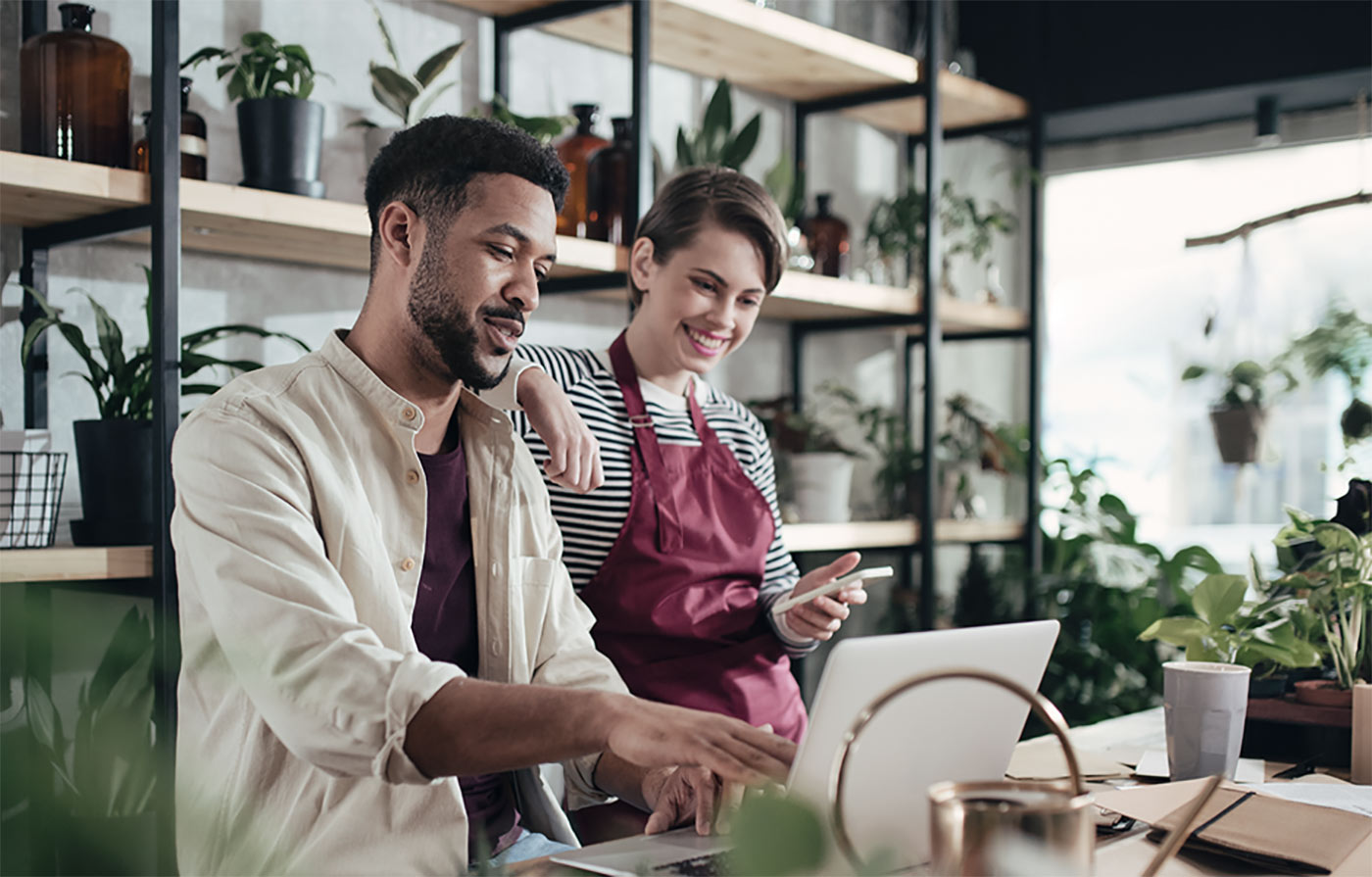 Man and woman looking at computer in flower shop